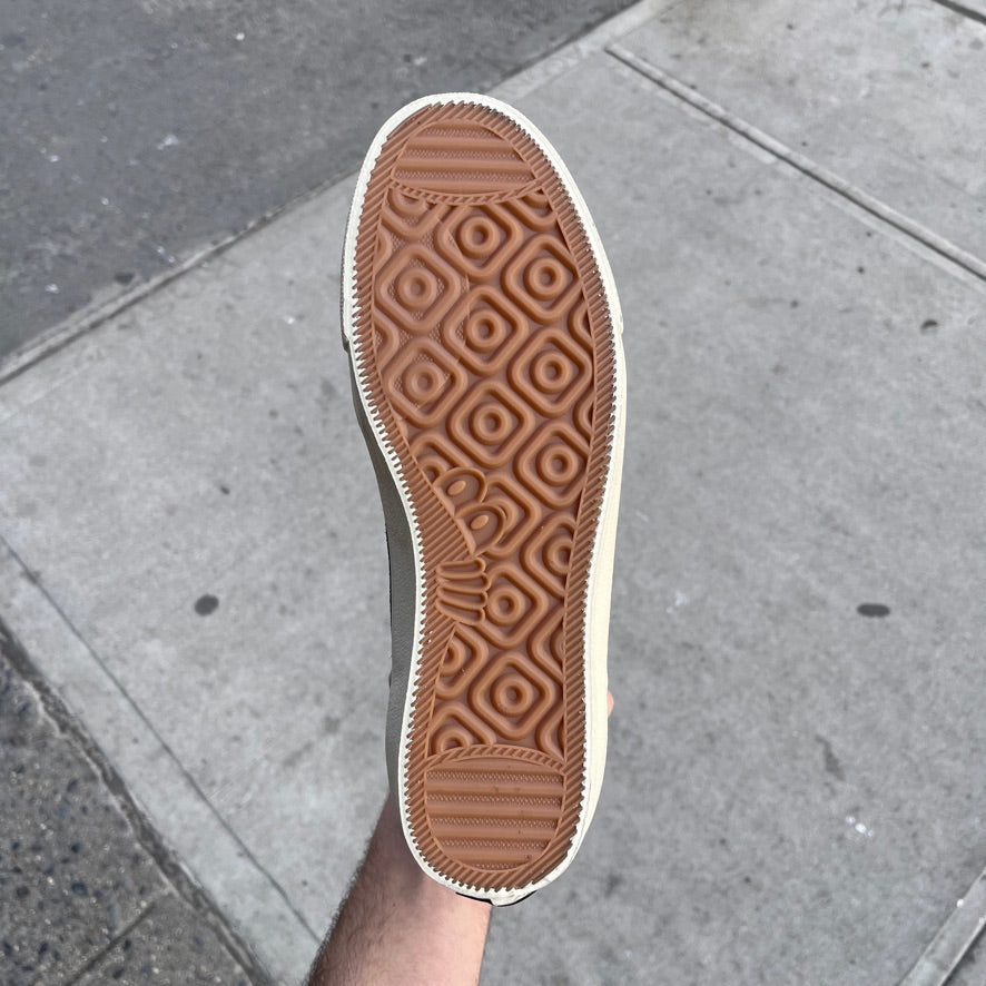 gum sole of the black and white suede high top skate shoes