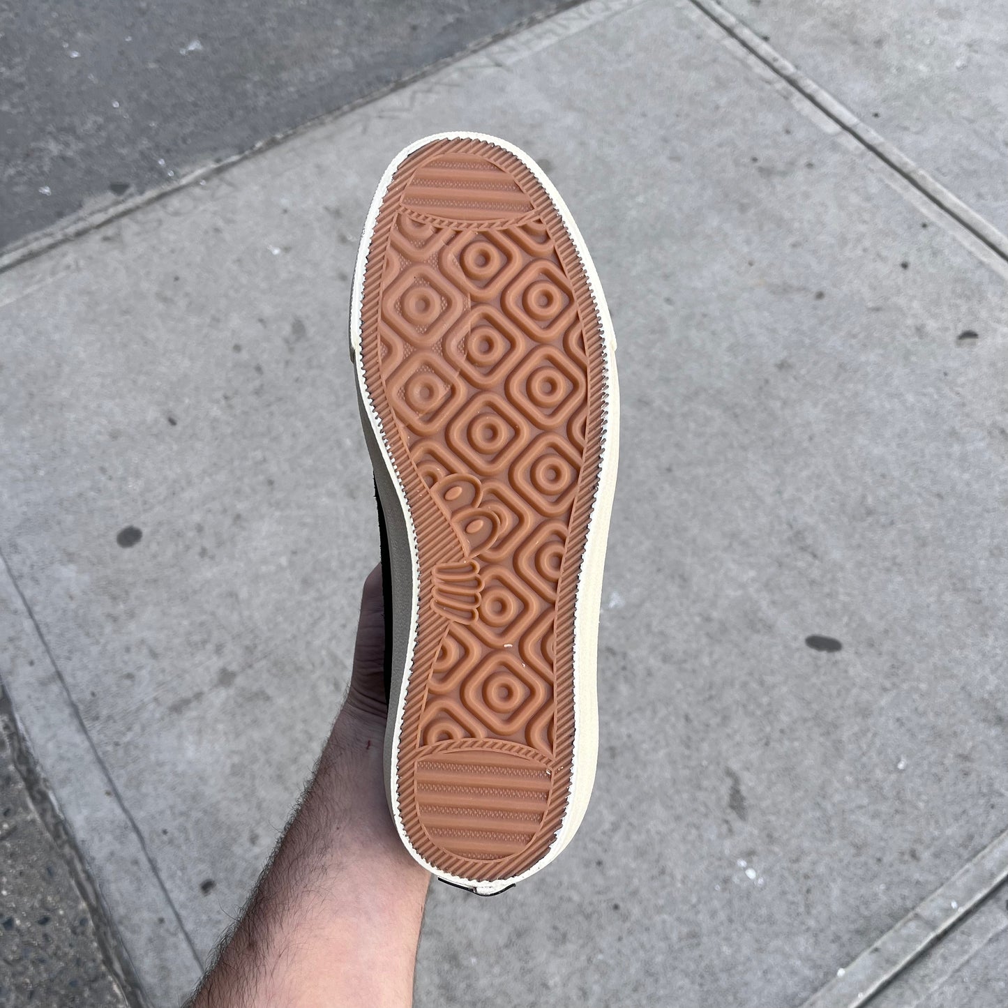 gum sole of the black and white low cut suede shoes