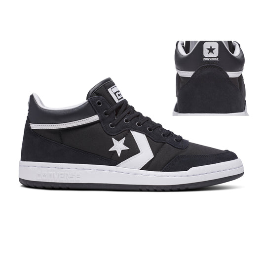 Side view of black/white suede and nylon mid top skateboard shoe, with heel photo set in the frame of the shoe