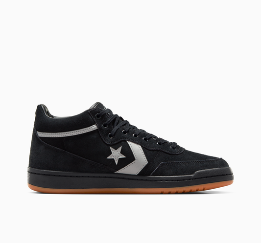 Side view of black suede mid top sneaker with grey star logo on side