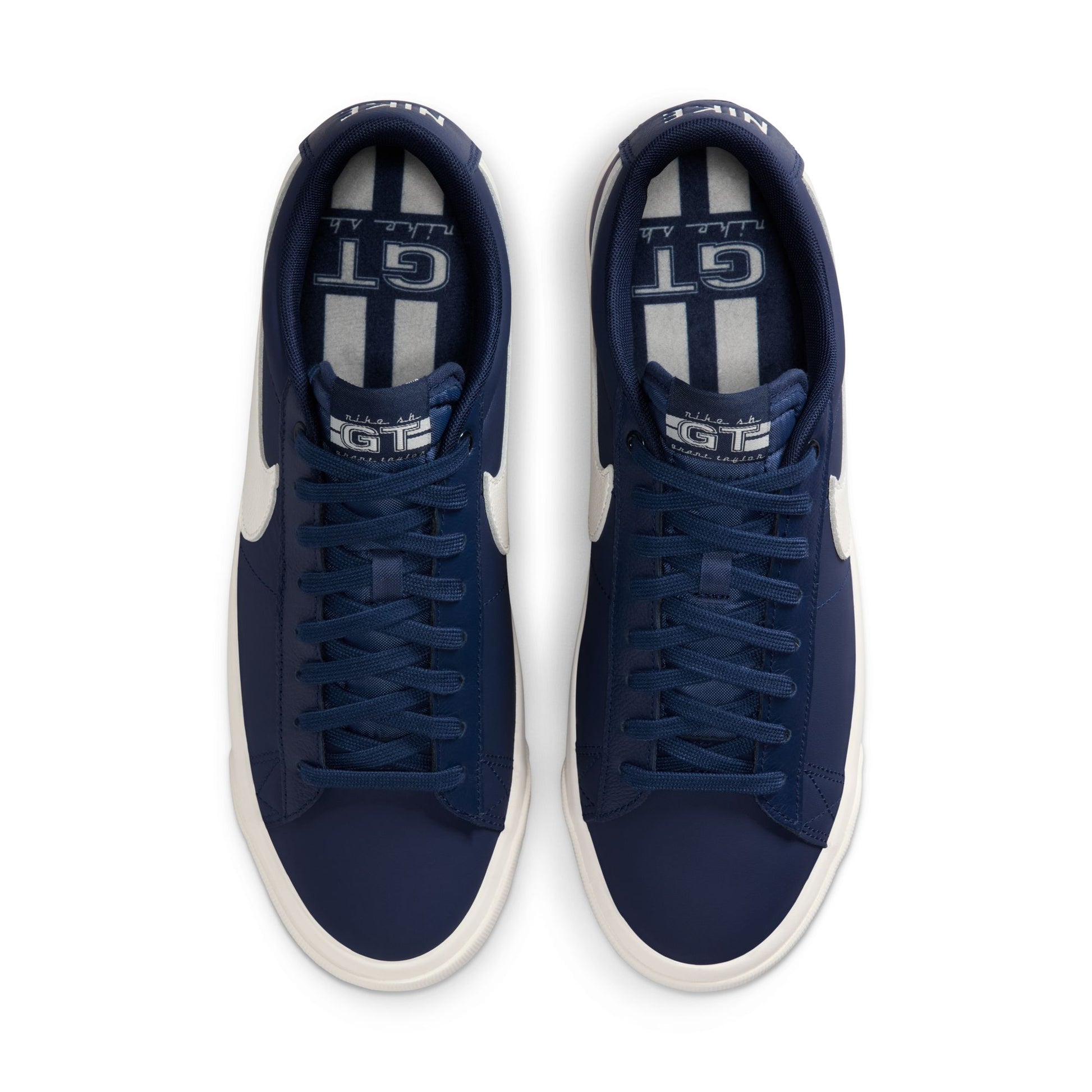 Pair of blue sneakers with white accents on a white background