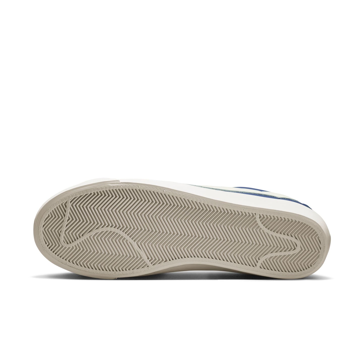 Close-up of a sneaker sole with tread pattern on a white background