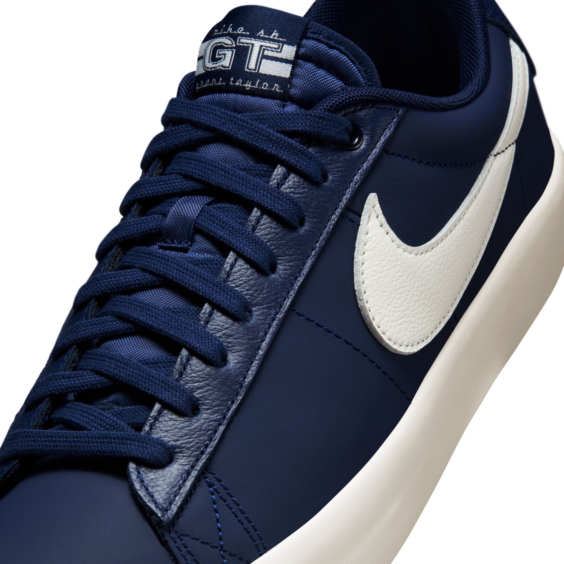 Navy blue sneaker with white swoosh logo on a white background