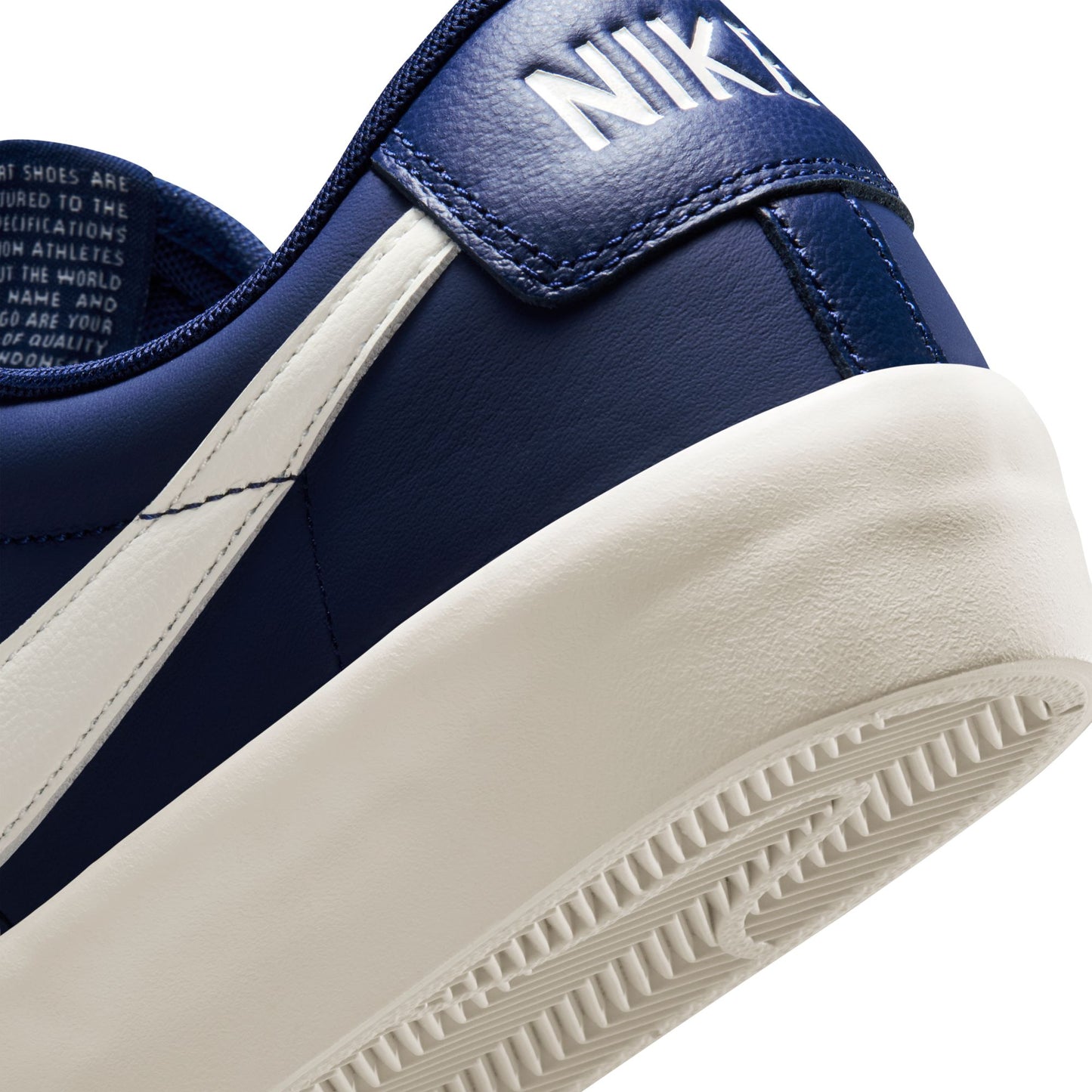 Close-up of a blue Nike sneaker with white sole on a white background