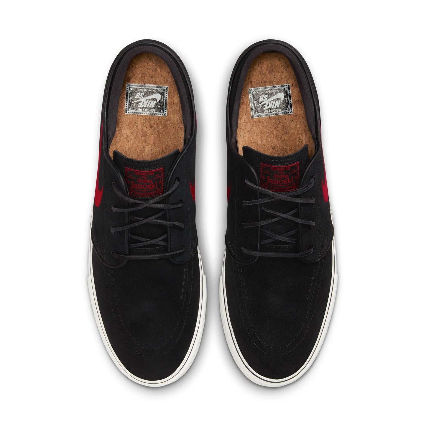 Black sneakers with red accents on a white background