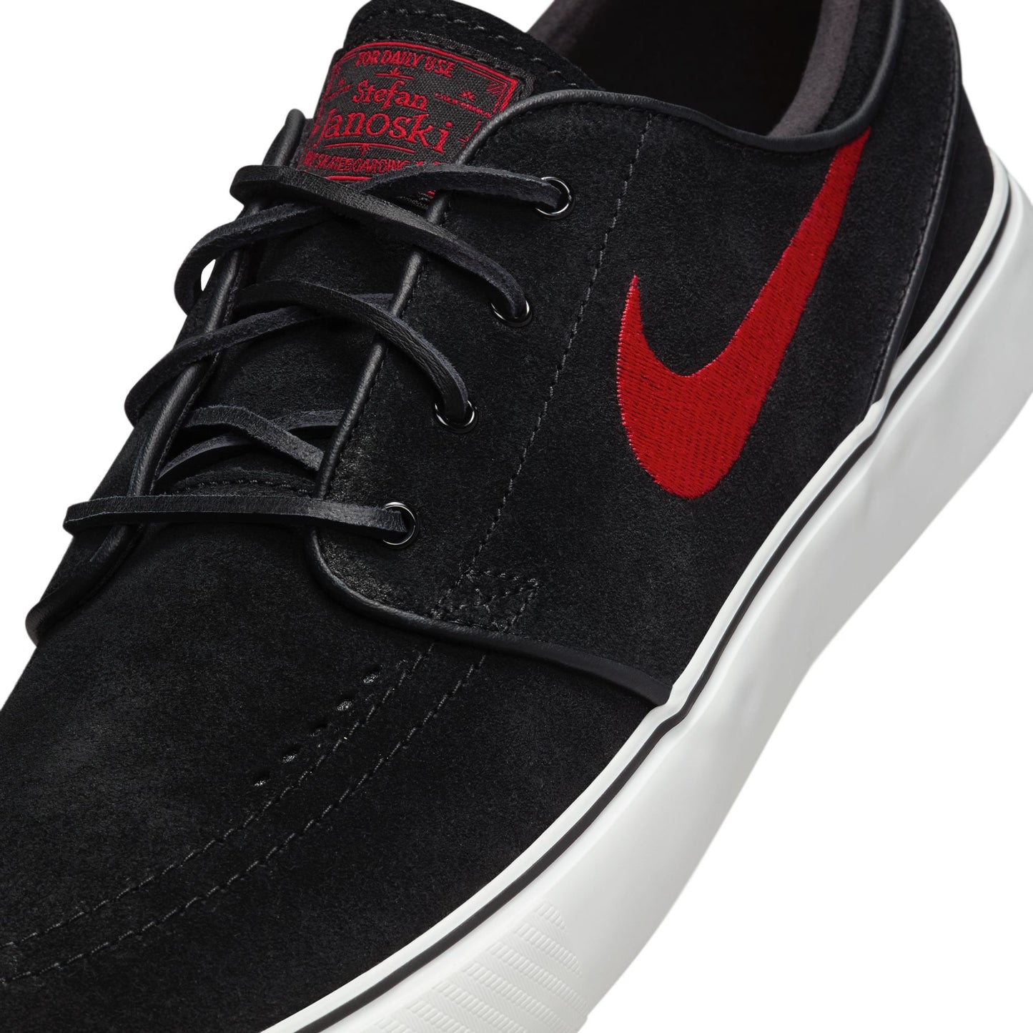 Black sneaker with red Nike logo on a white background