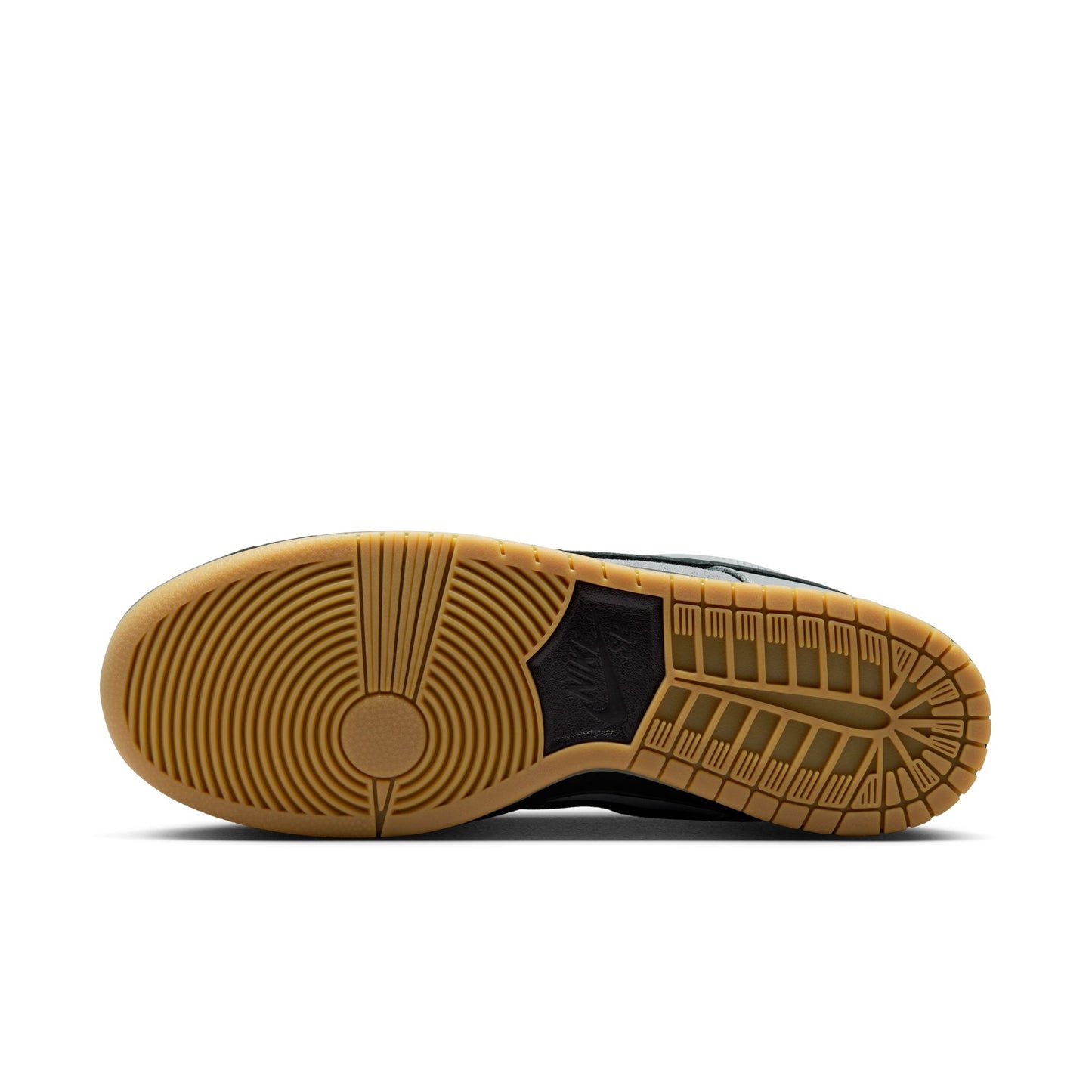 Close-up of a shoe sole with brown tread pattern on a white background
