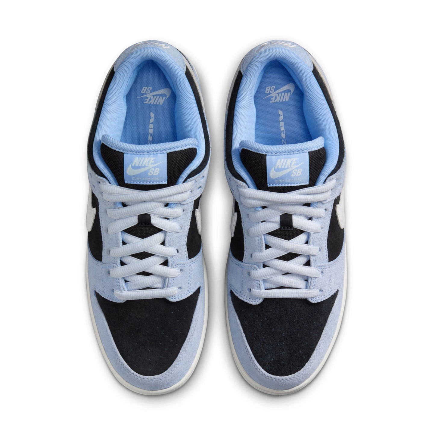 top down view of light blue, white, and black suede low top Nike sb sneakers