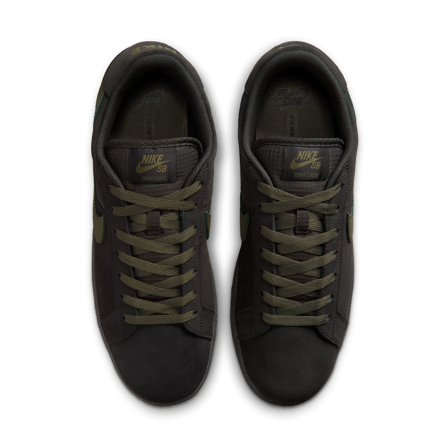 Pair of black Nike sneakers with green laces on a white background