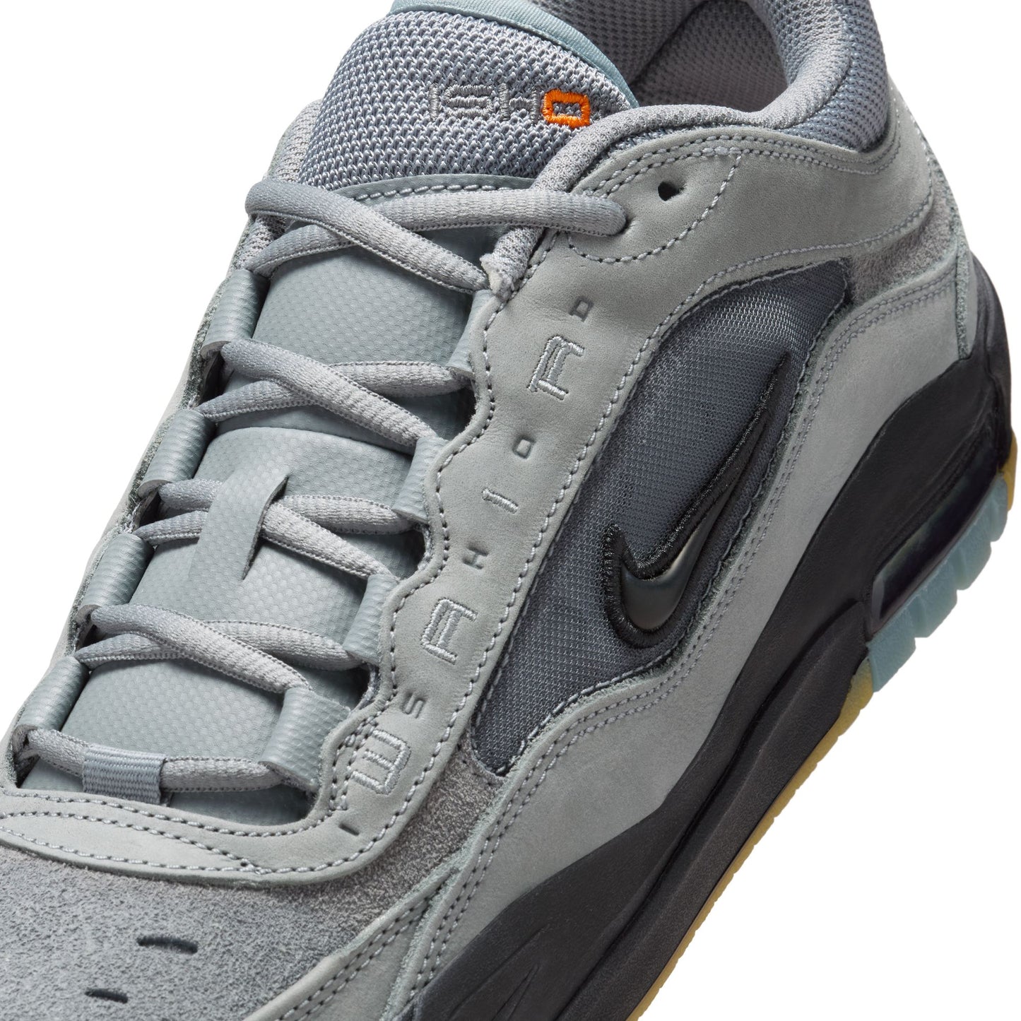 Gray sneaker with black swoosh logo on a white background