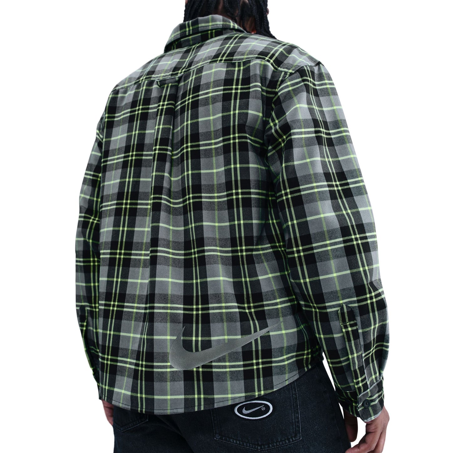Green and black plaid shirt worn by a person on a white background