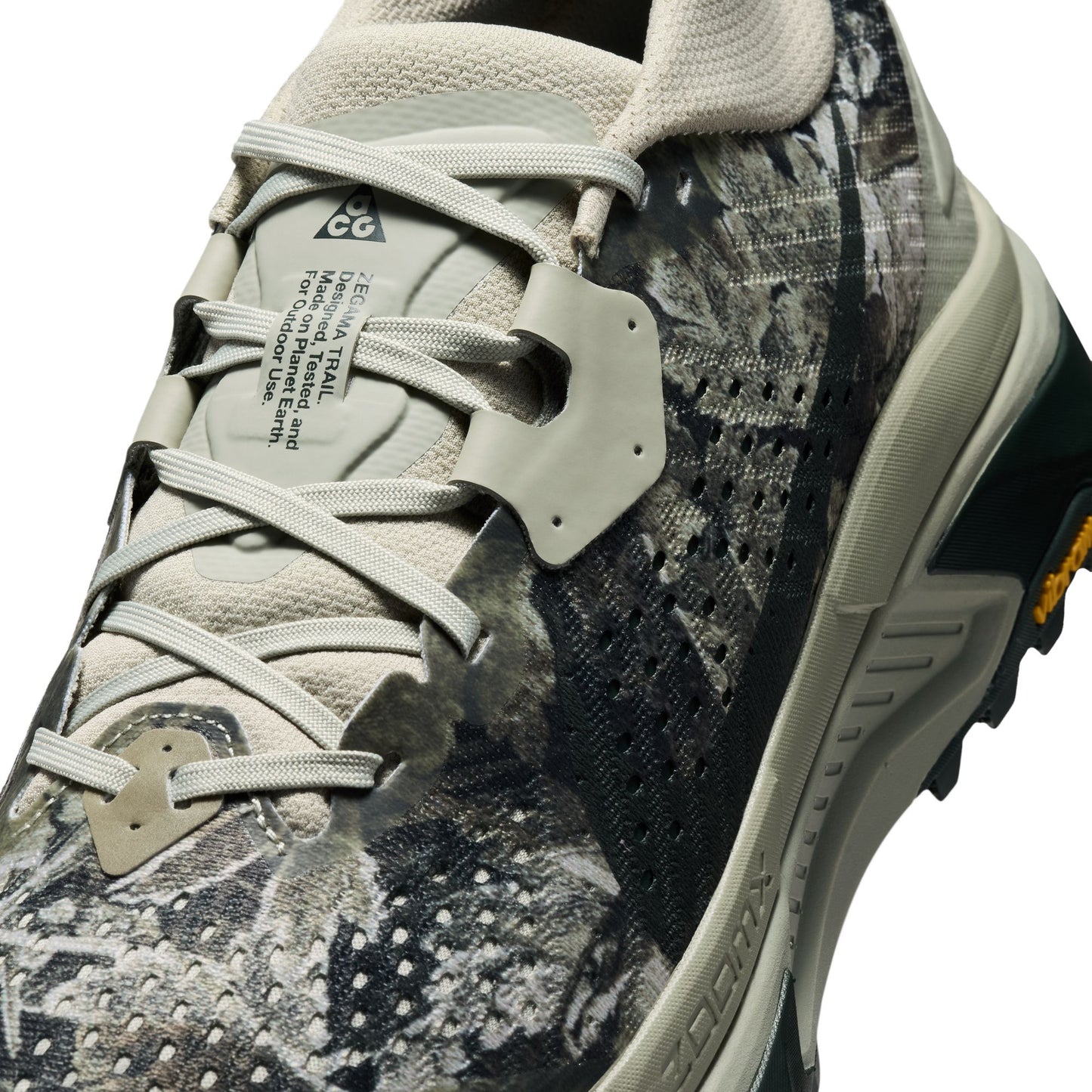 Camouflage trail running sneaker with brand logo on a white background