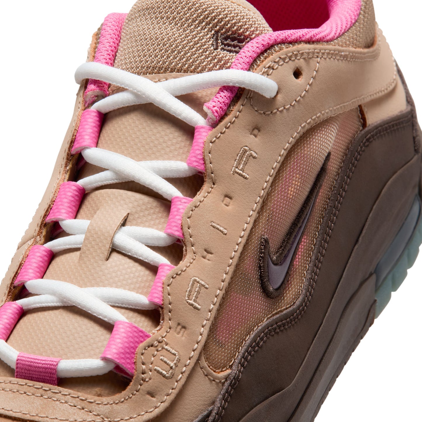 close up of Tan sneaker with pink and white laces on a white background
