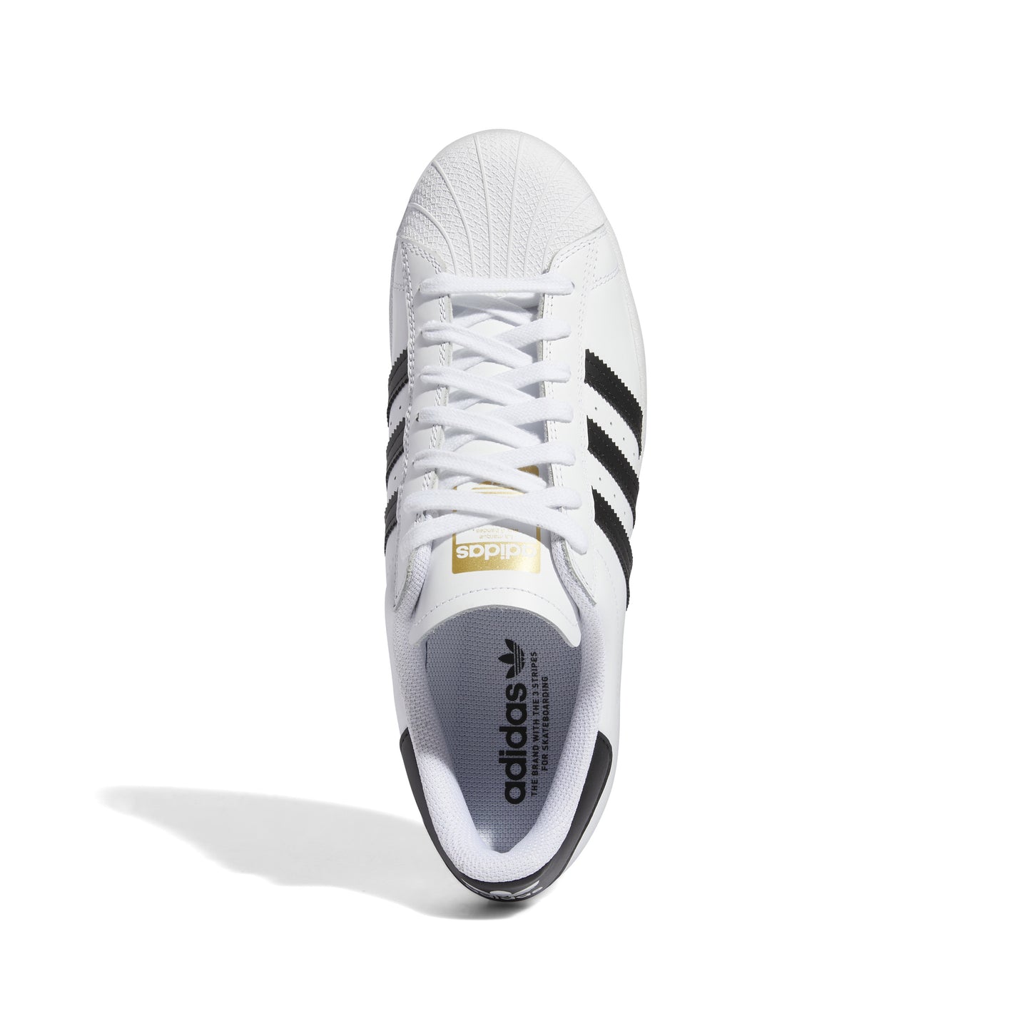 top down view of white leather lowtop skatebaord sneaker with black stripes and black heel tab