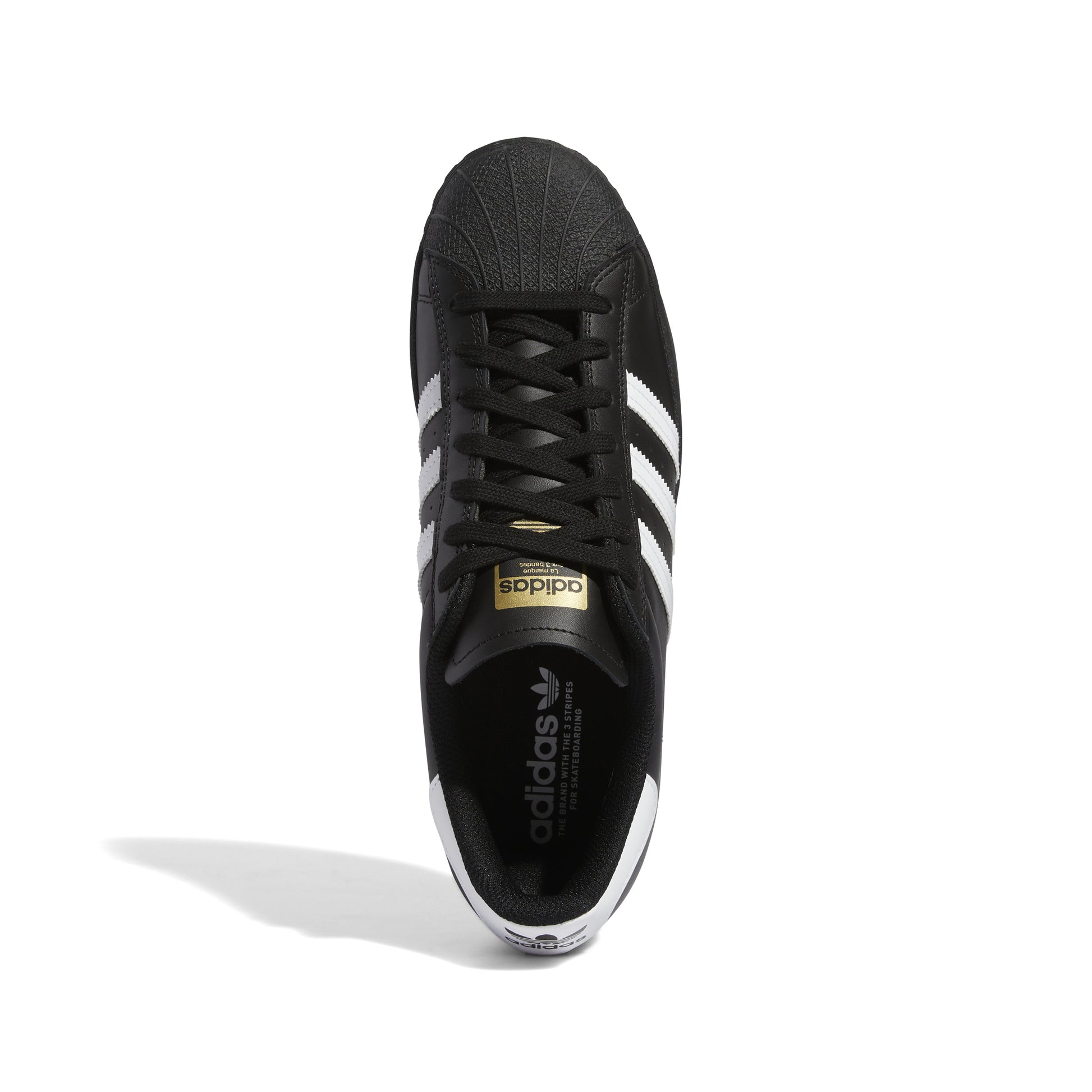 top down view of black leather adidas superstar with white stripes and heel tab