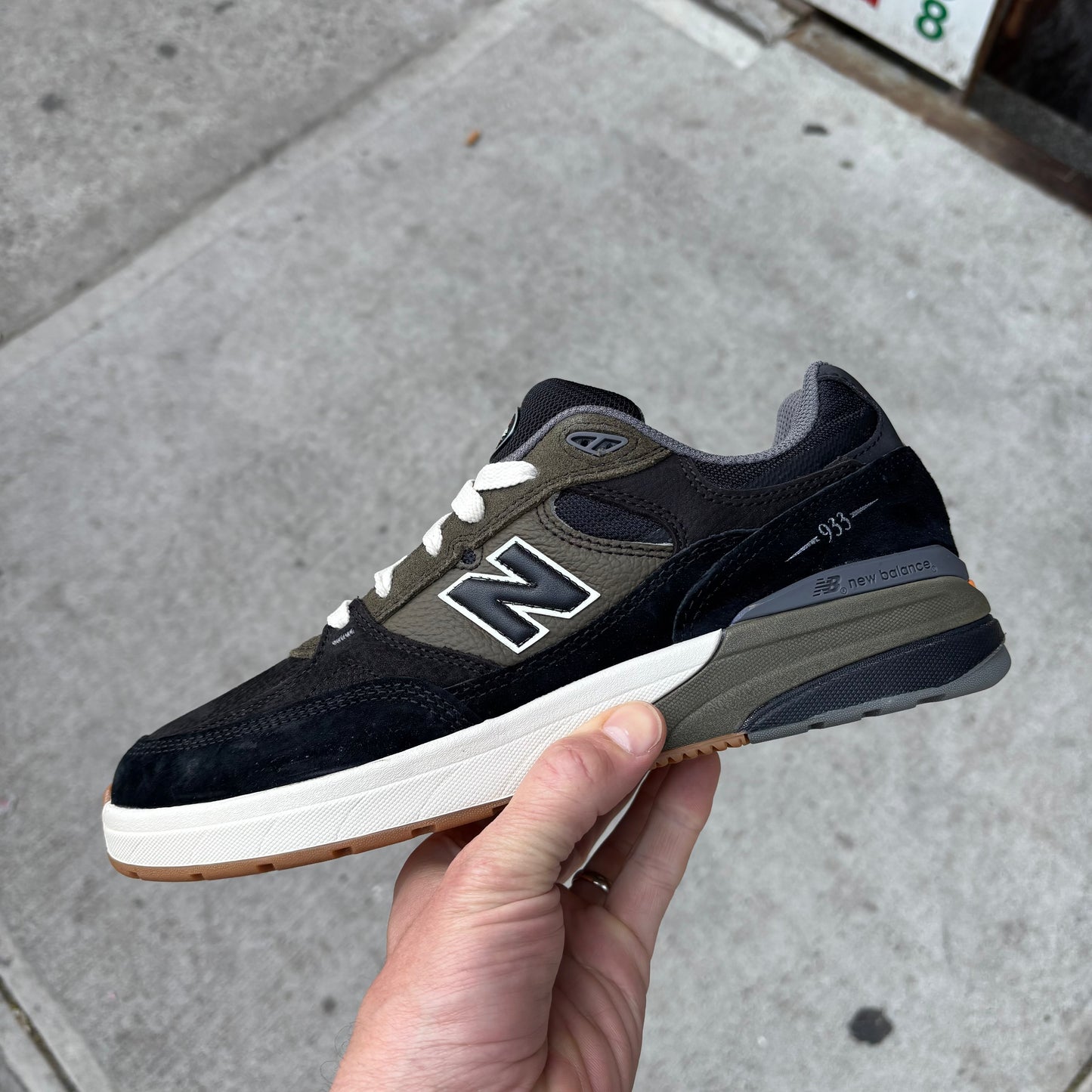side view of black, green and white skateboard shoe