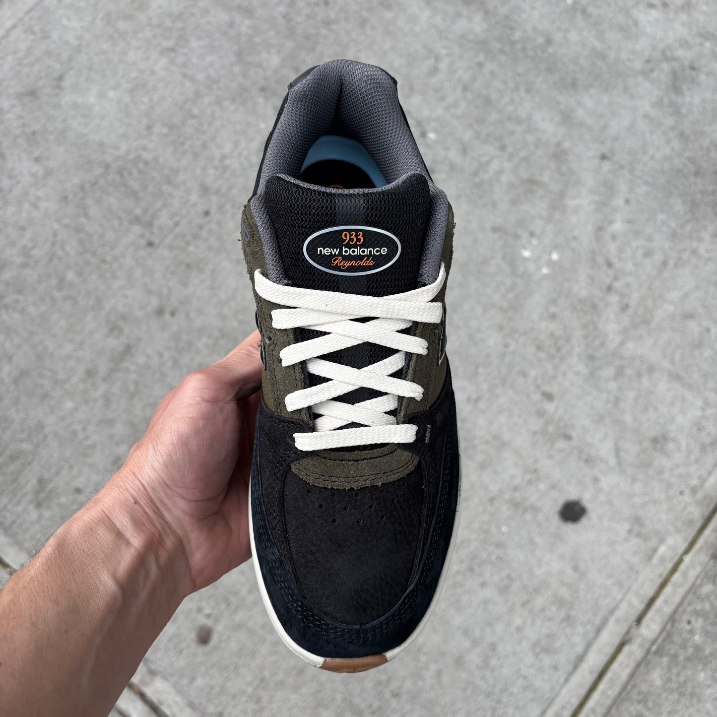 top down view of black, green and white skateboard shoe
