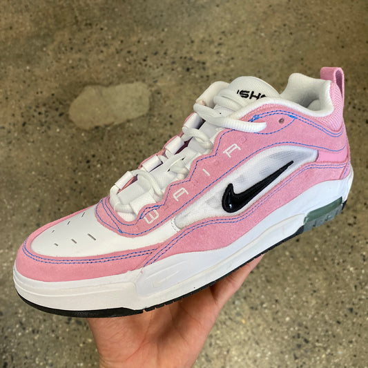 pink and white shoe with black swoosh