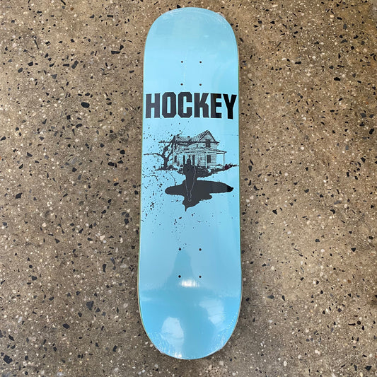 light blue skateboard deck with black  text and black line illustration of a house
