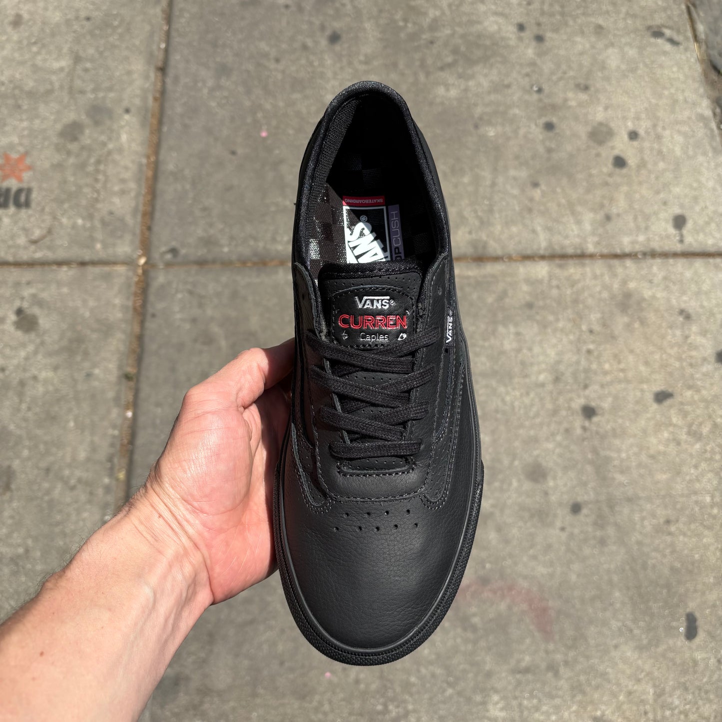 top down view of black leather low top skateboard sneaker