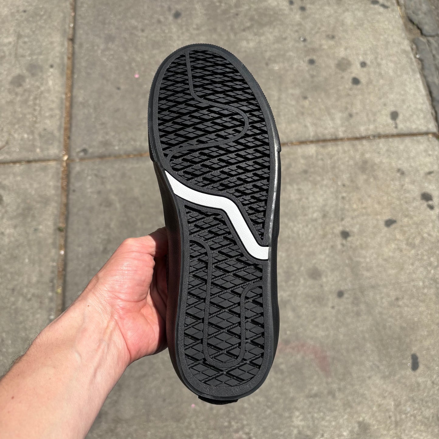 view of vans outsole on black leather low top skateboard sneaker