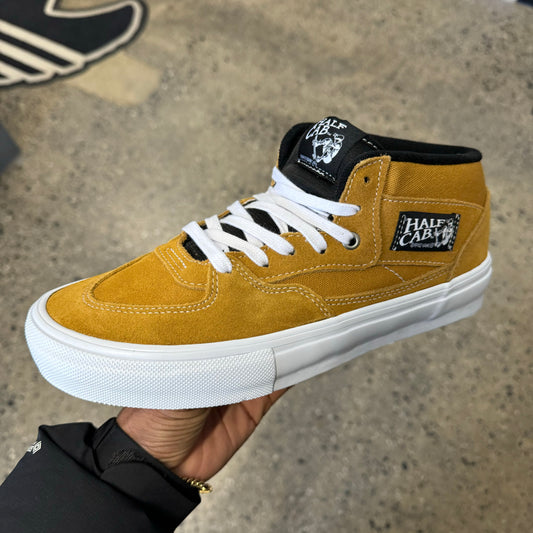 Side view of gold suede and canvas skateboard shoe
