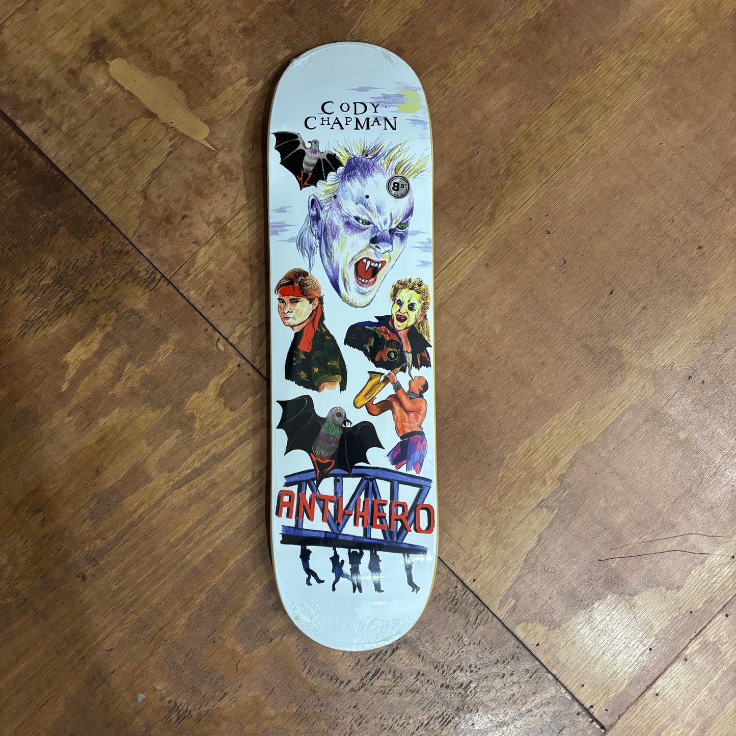 white skateboard deck with movie characters hand drawn on the deck