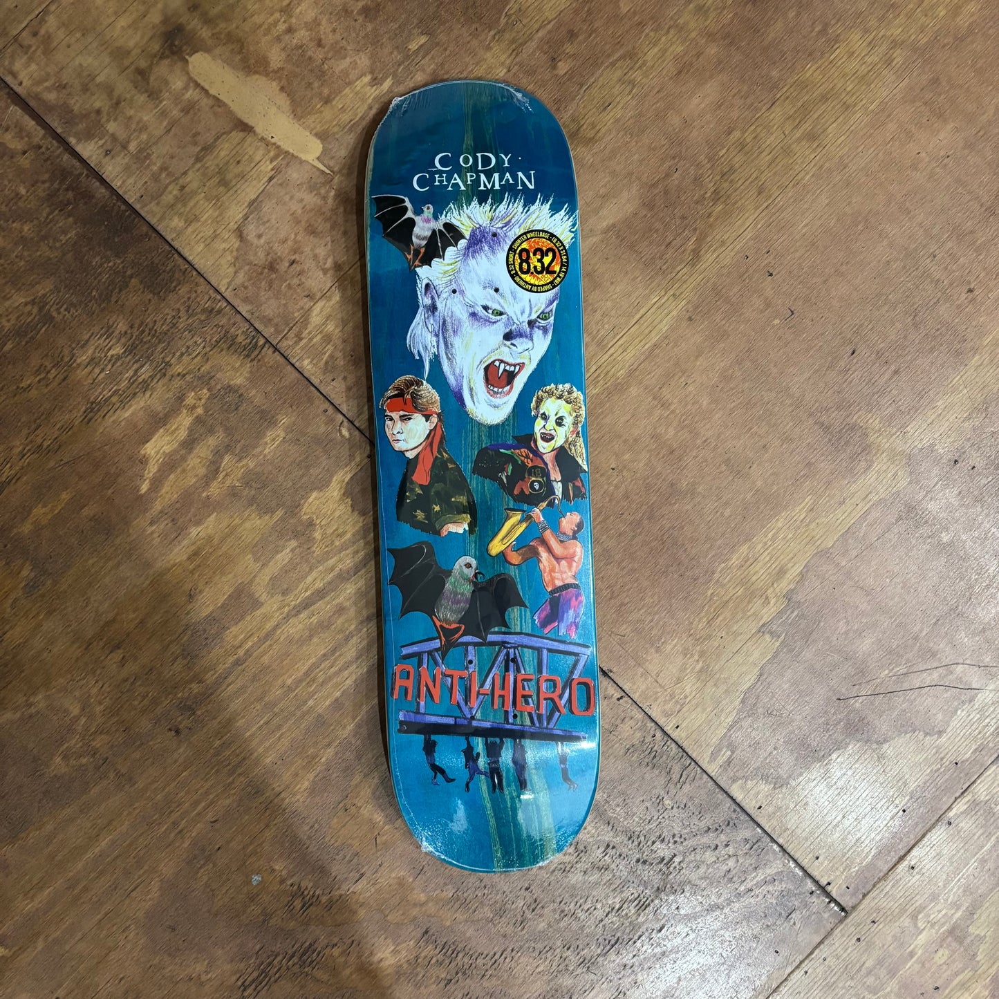 woodgrain skateboard deck with movie characters hand drawn on the deck