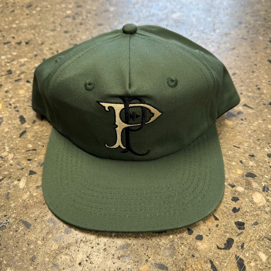 green hat with cream and black logo