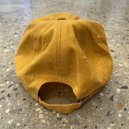 rear of gold waxed canvas six panel cap