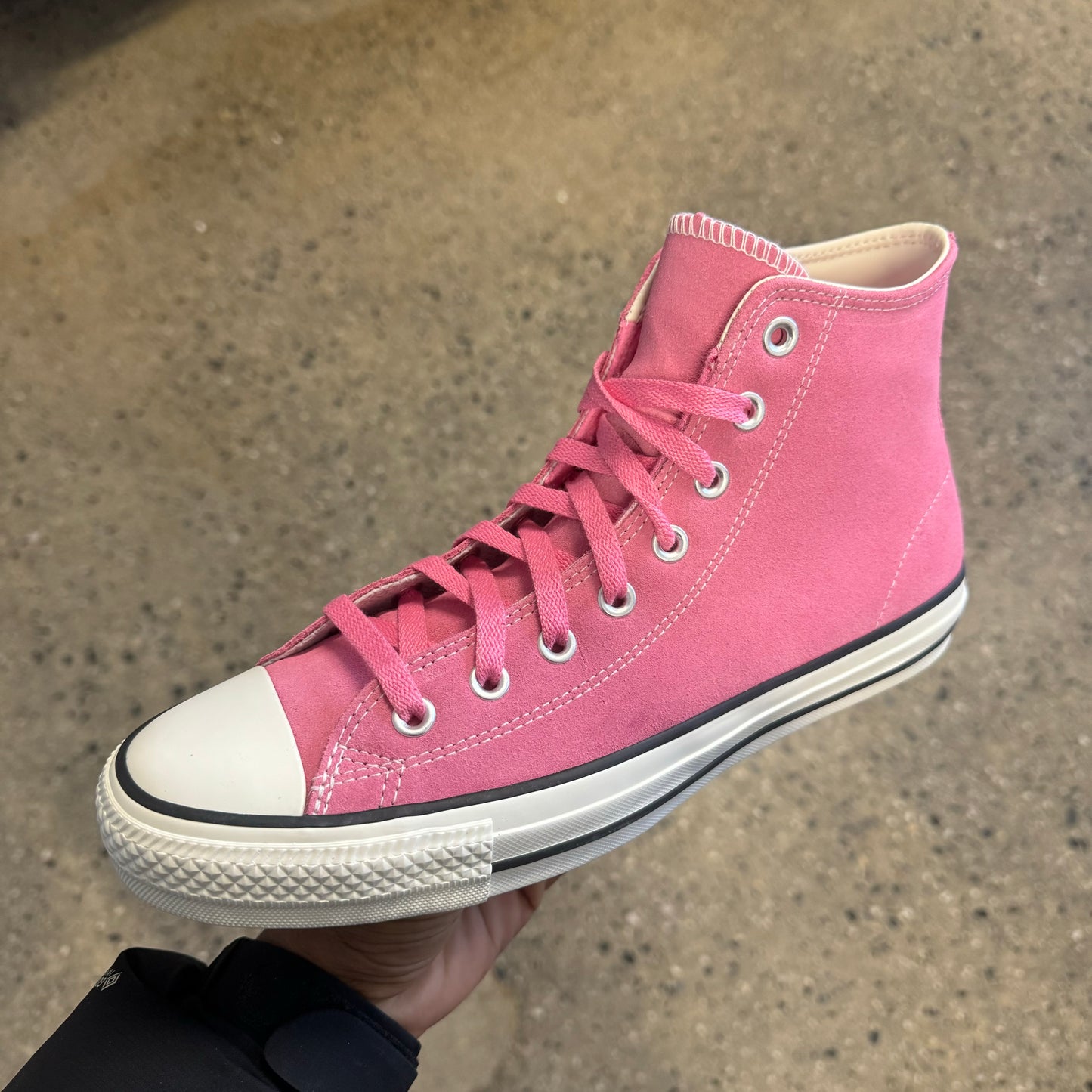 pink hi top sneaker with white sole and toe, side view