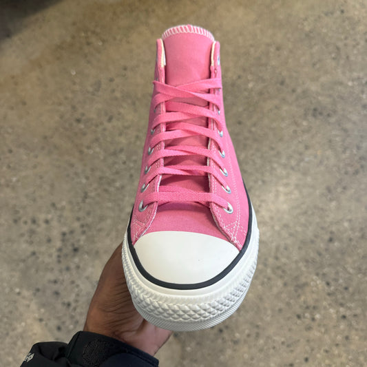 pink hi top sneaker with white sole and toe, front view