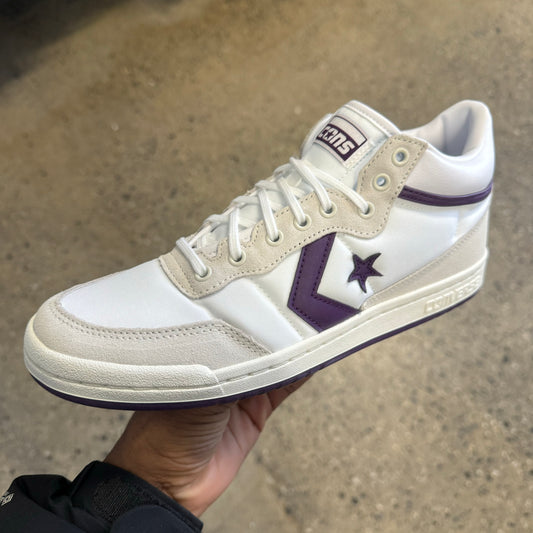 white sneaker with purple stripe and star, side view