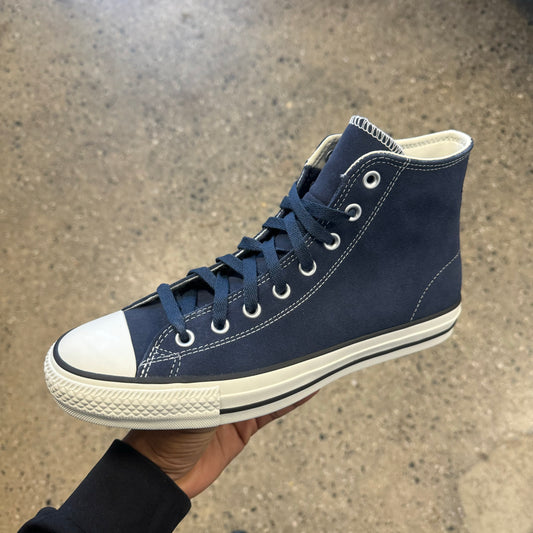 navy suede hi top sneaker with white sole, toe, and stitch