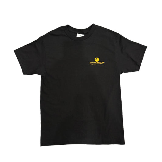 Black t-shirt with a yellow logo on a white surface
