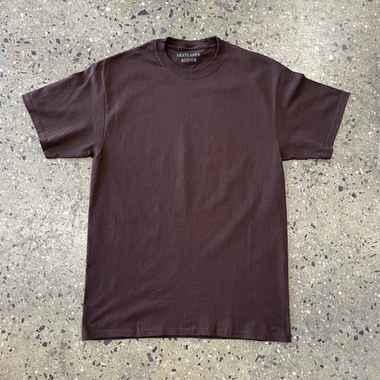 white sewer cap on brown T-shirt