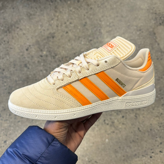 tan canvas and suede sneaker with orange stripes, side view