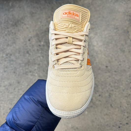 tan canvas and suede sneaker with orange stripes, front view