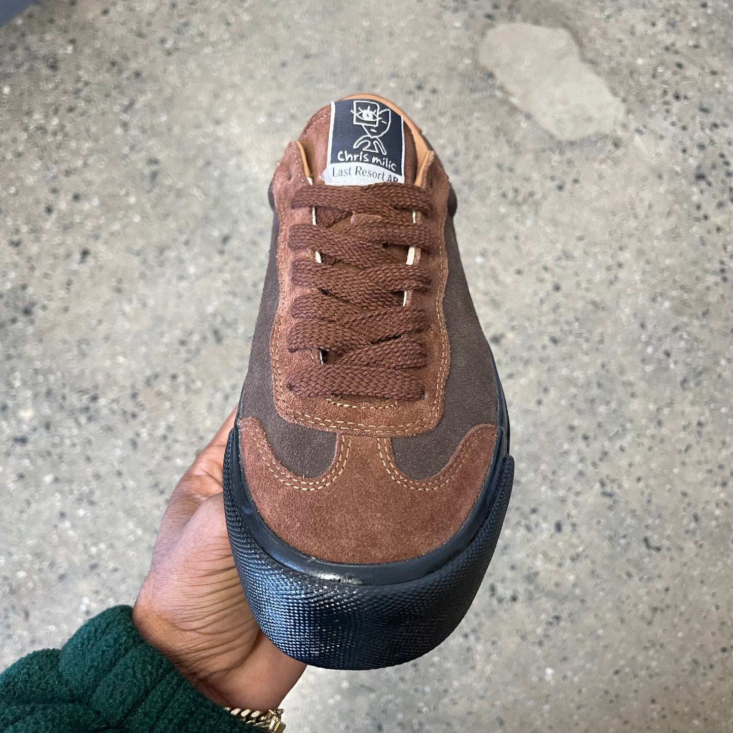 two toned brown suede sneaker with black sole, front view