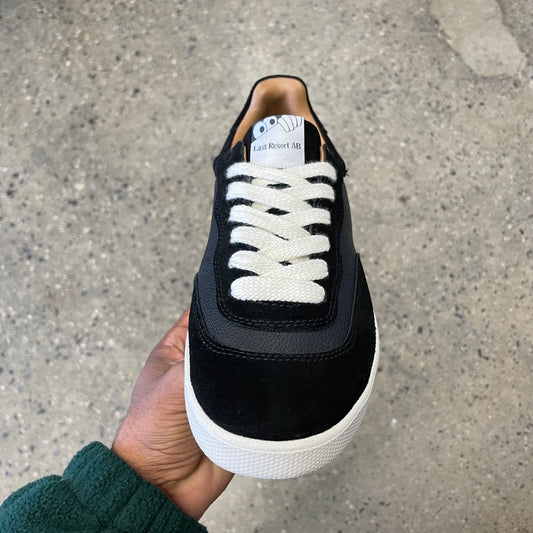 black leather and suede sneaker with white sole, front view