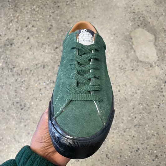 green suede sneaker with black sole, front view