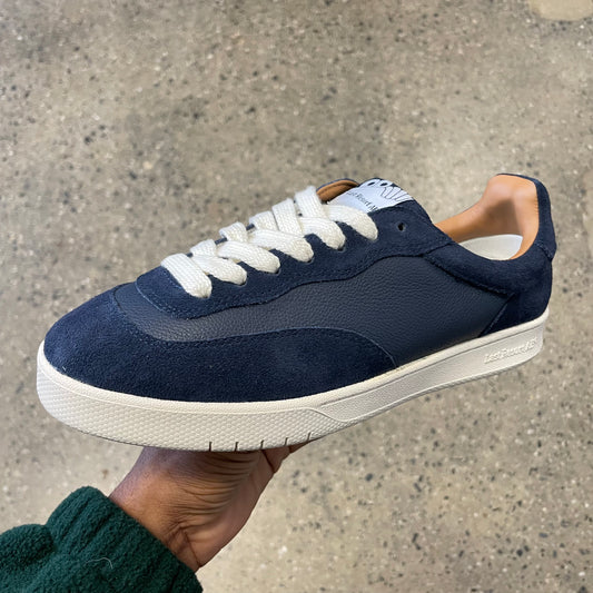 navy leather and suede sneaker with white sole, side view