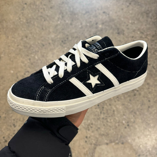 black suede sneaker with white stripes, star, sole, and stitch