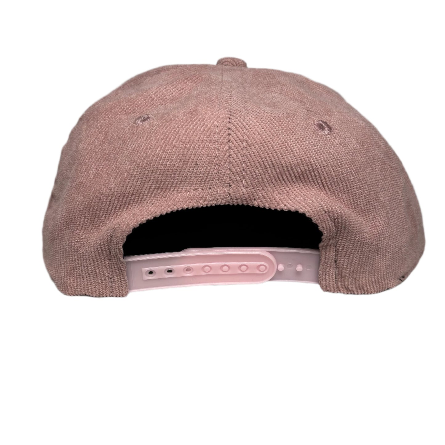 Pink corduroy cap on a white surface