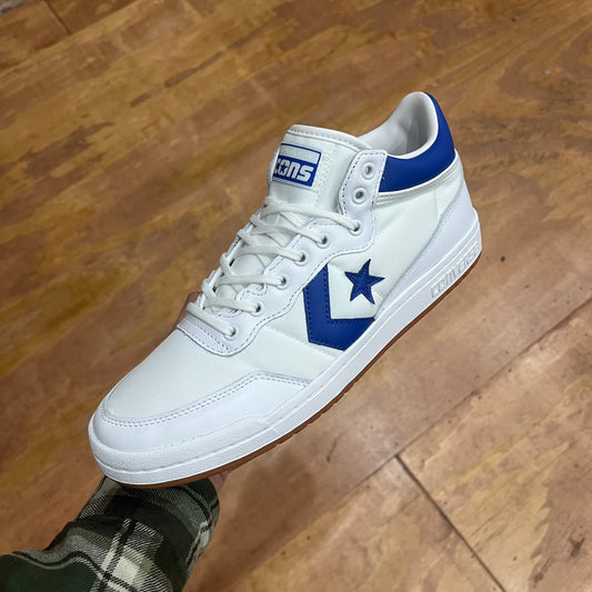 white sneaker with blue stripe and star, side view