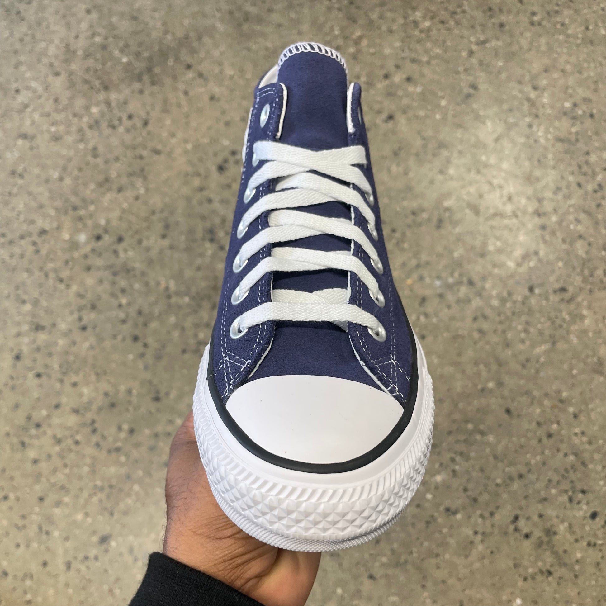 blue suede sneaker with white sole, toe, and stitch, front view