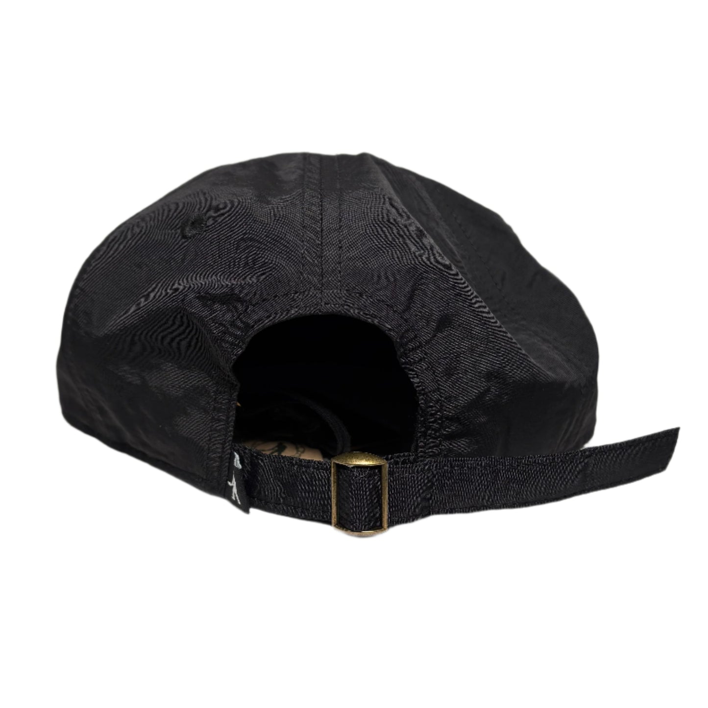 Black cap with a gold buckle on a white surface