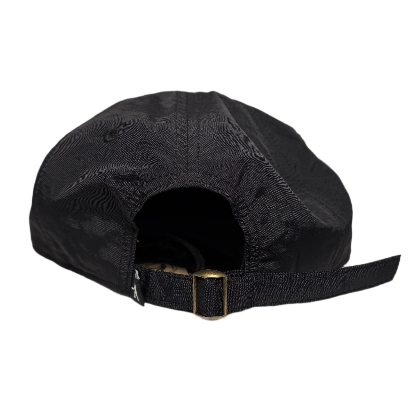 Black cap with a gold buckle on a white surface