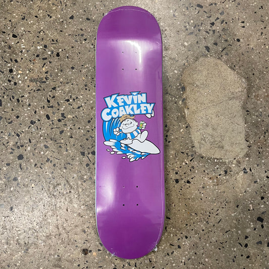 White and blue kevin coakley logo deck of man surfing, on purple skate deck