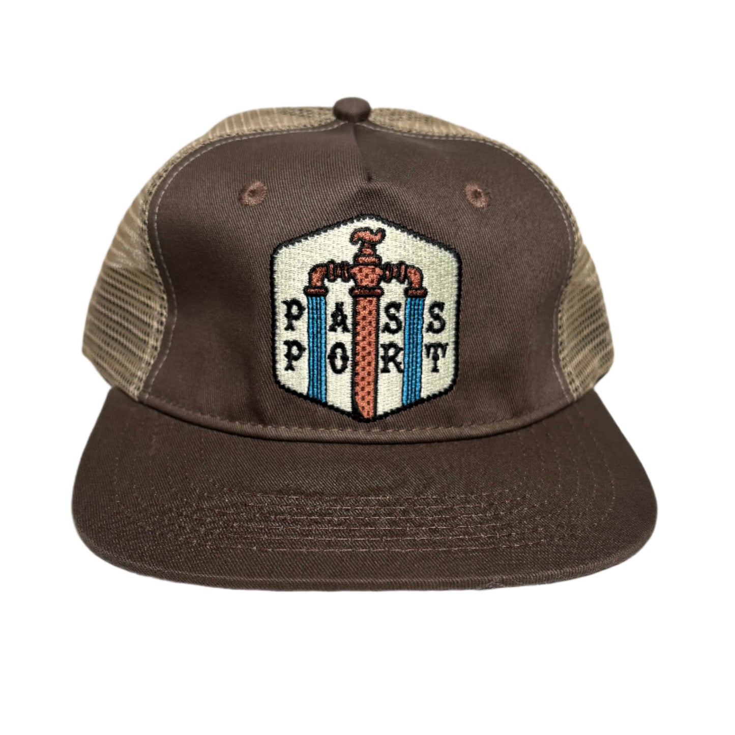 Brown cap with a decorative patch on a white surface